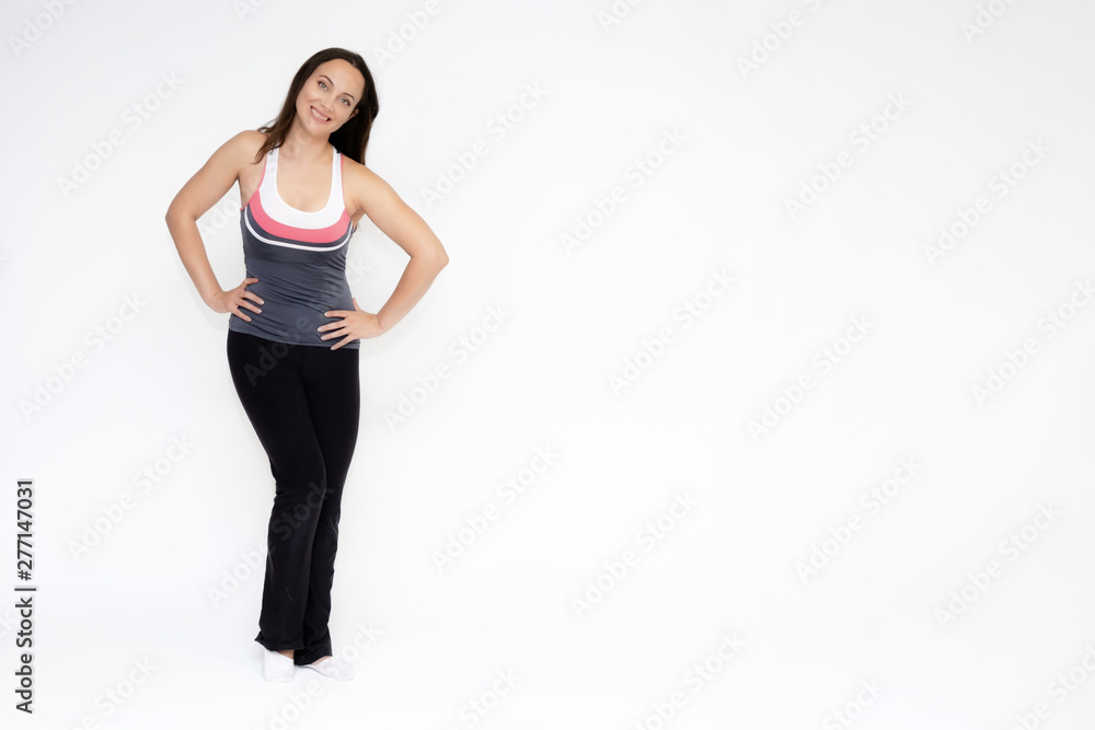 Full-length portrait on white background of beautiful pretty fitness girl woman in sports uniform, standing with different emotions in different poses, showing hands. Smiles Stylish trendy youth. Full-length portrait on white background of beautiful pretty fitness girl woman in sports uniform, standing with different emotions in different poses, showing hands. Smiles Stylish trendy youth.