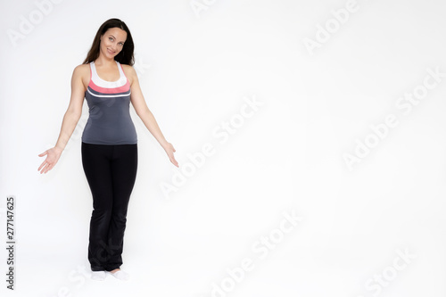 Full-length portrait on white background of beautiful pretty fitness girl woman in sports uniform, sitting on the stairs with different emotions in different poses. Stylish trendy youth.