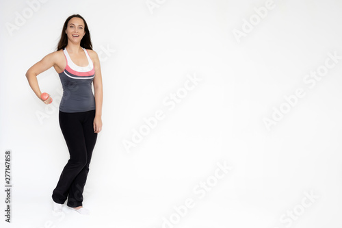 Full-length portrait on white background of beautiful pretty fitness girl woman in sports uniform, sitting on the stairs with different emotions in different poses. Stylish trendy youth.