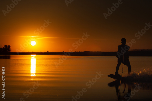 wakeboard  athlete silhouette on sunset background