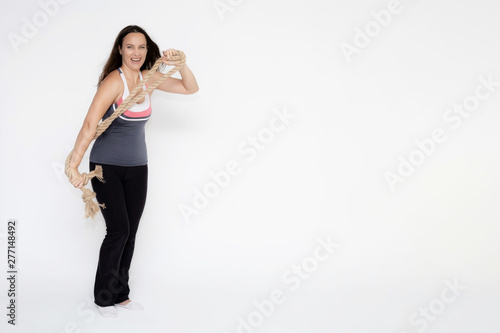 Full-length portrait on white background of beautiful pretty fitness girl woman in sport uniform with rope in hands, with different emotions in different poses. Stylish trendy youth.