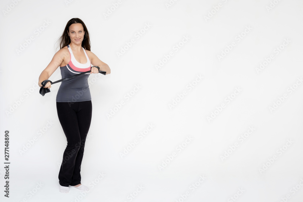 Full-length portrait on white background of beautiful pretty fitness girl woman in sports uniform with rubber expander in hands, with different emotions in different poses. Stylish trendy youth. Full-length portrait on white background of beautiful pretty fitness girl woman in sports uniform with rubber expander in hands, with different emotions in different poses. Stylish trendy youth.