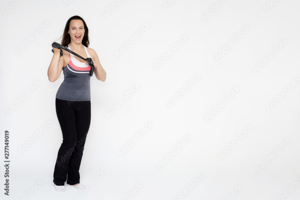 Full-length portrait on white background of beautiful pretty fitness girl woman in sports uniform with rubber expander in hands, with different emotions in different poses. Stylish trendy youth. Full-length portrait on white background of beautiful pretty fitness girl woman in sports uniform with rubber expander in hands, with different emotions in different poses. Stylish trendy youth.