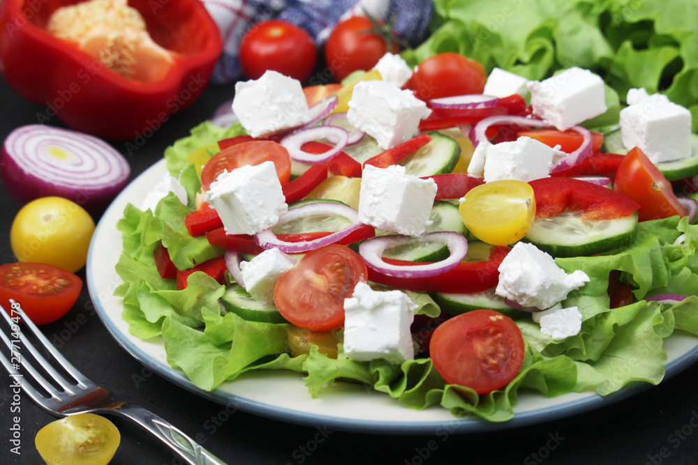 A plate full of bright fresh vegetable salad A plate full of bright fresh vegetable salad