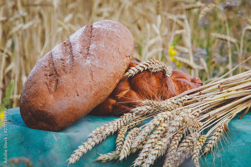 bakery products in a basket on a wheat field bakery products in a basket on a wheat field