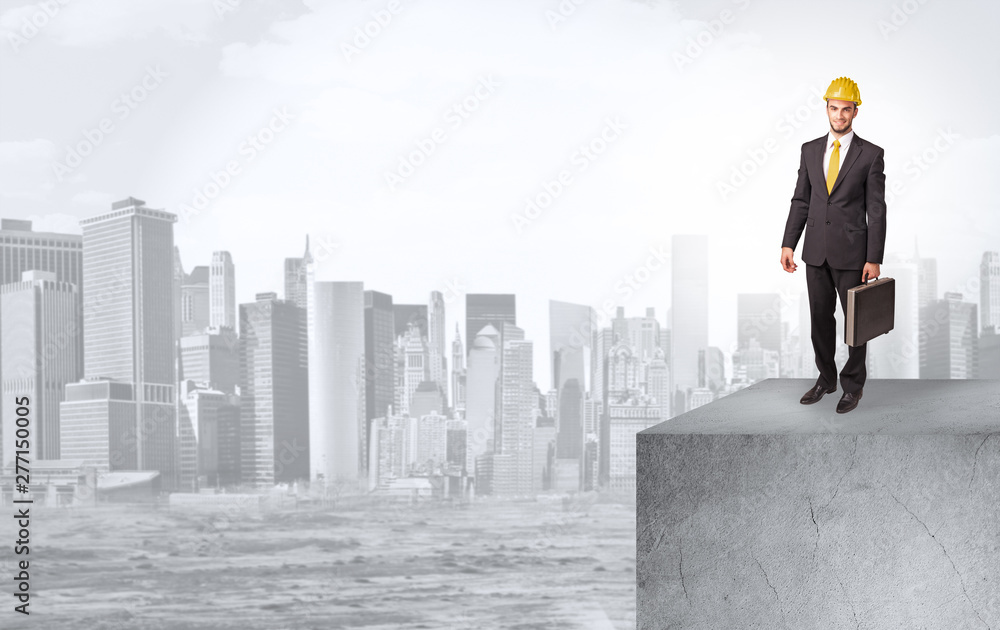 Young investor looking to the city from distance and thinking about investment Young investor looking to the city from distance and thinking about investment