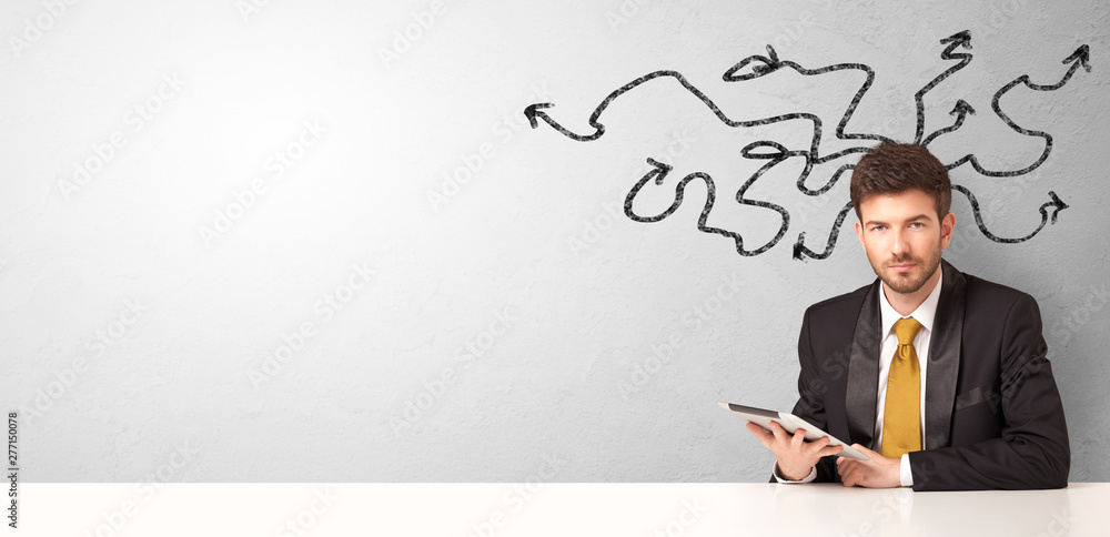 Businessman sitting at desk with direction concept Businessman sitting at desk with direction concept