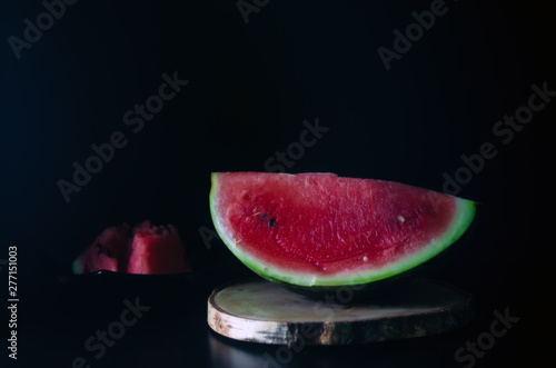sliced juicy ripe watermelon on a dark background for the menu