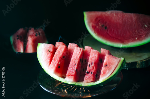 sliced juicy ripe watermelon on a dark background for the menu