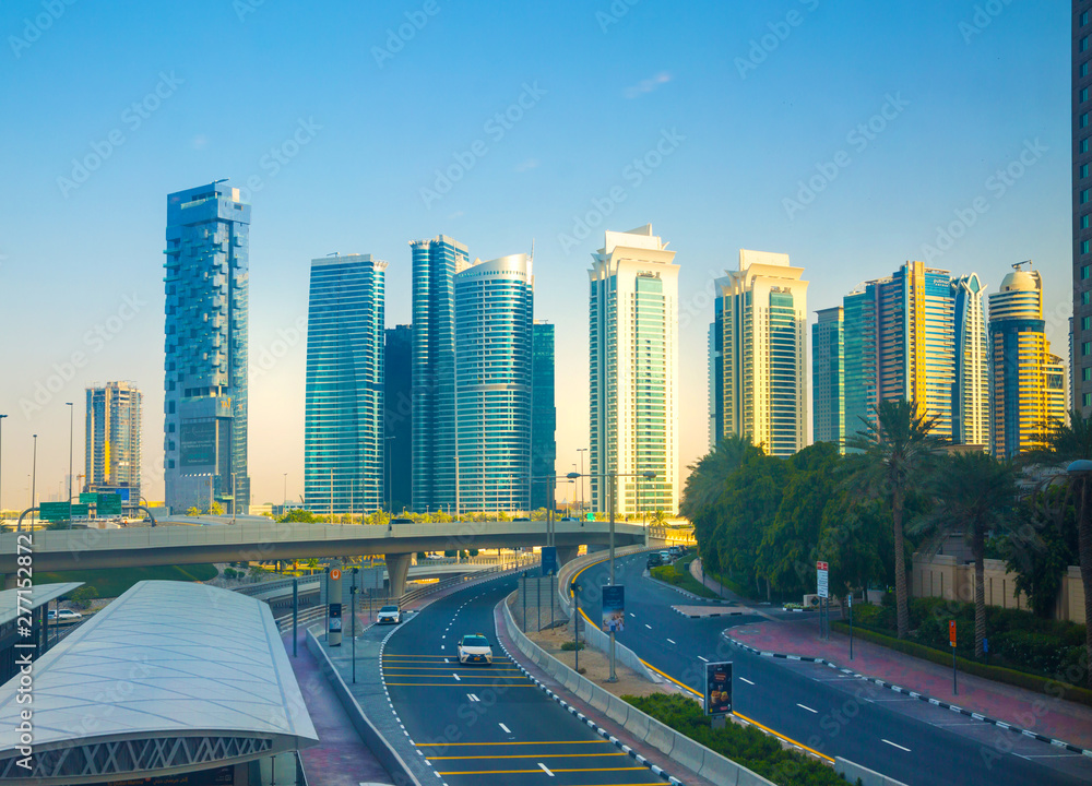 Dubai, UAE. Sheikh Zayed road and skyscrapers at sunset. Apartments, hotels and office buildings of UAE