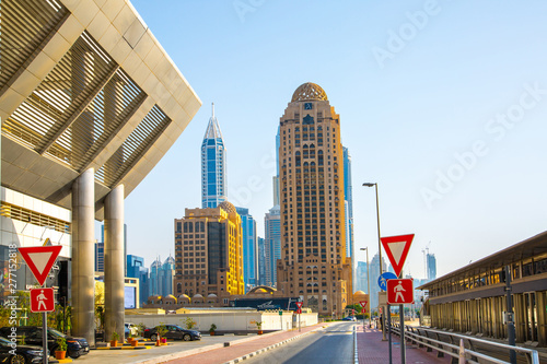 Dubai, UAE United Arabs Emirates. Arjaan building and Dubai marina skyscrapers at the background. King Salman Al Saud highway tram station. Hotels and office buildings of UAE photo