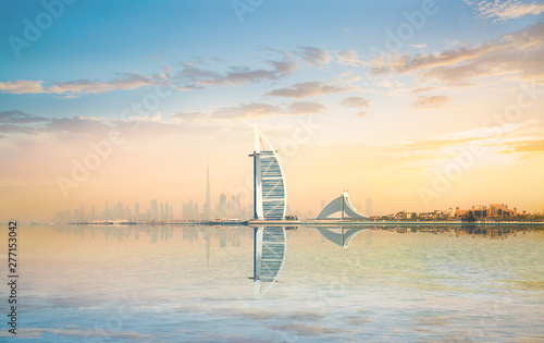 Beautiful Dubai skyline at the early morning with city reflection in the calm water of Persian gulf  © IRStone