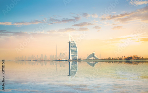 Photography Beautiful Dubai skyline at the early morning with city reflection in the calm wa