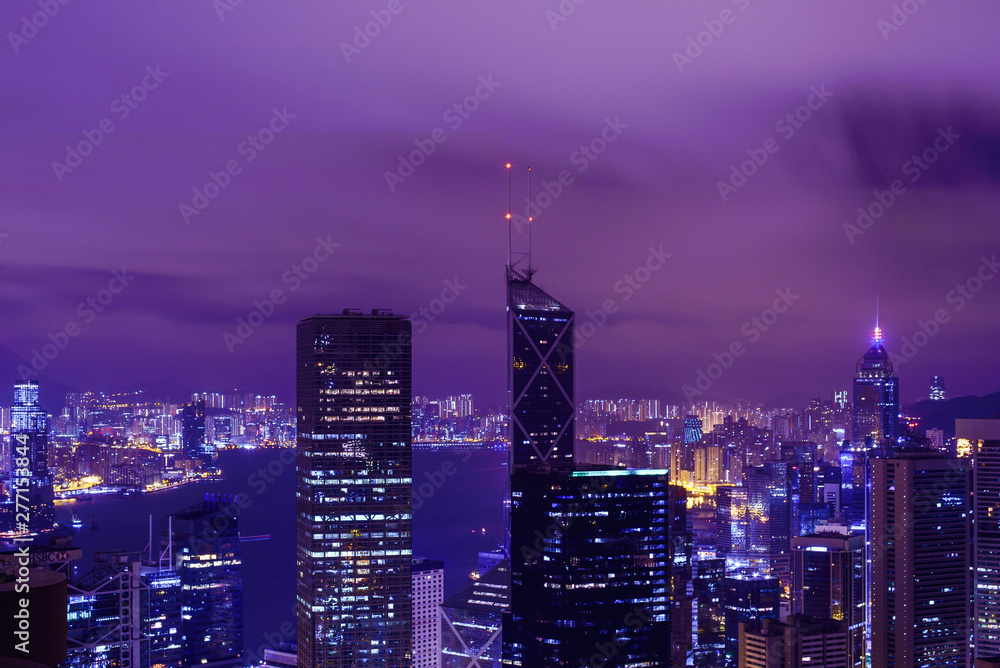 Fototapeta premium Famous view of Hong Kong at twilight sunset, sunrise. Hong Kong skyscrapers skyline cityscape illuminated in the evening. Hong Kong, special administrative region in China. China shopping market. Blue