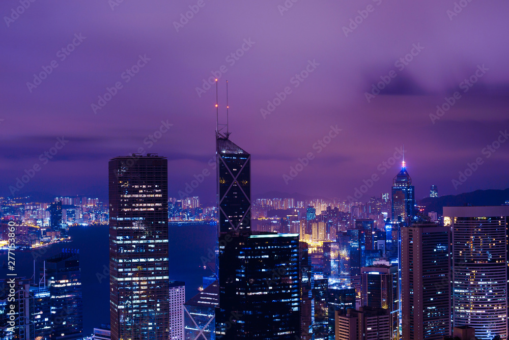 Famous view of Hong Kong at twilight sunset, sunrise. Hong Kong skyscrapers skyline cityscape illuminated in the evening. Hong Kong, special administrative region in China. China shopping market. Blue