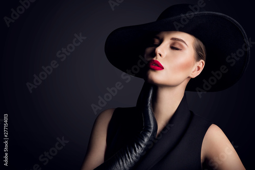 Woman Beauty in wide brim Hat, Elegant Fashion Model Retro Portrait on Black photo