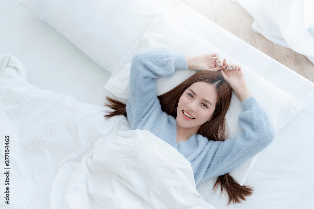 beautiful asian woman blue sweater lay done on white bed casual lifestyle morning time weekend concept top view beautiful asian woman blue sweater lay done on white bed casual lifestyle morning time weekend concept top view