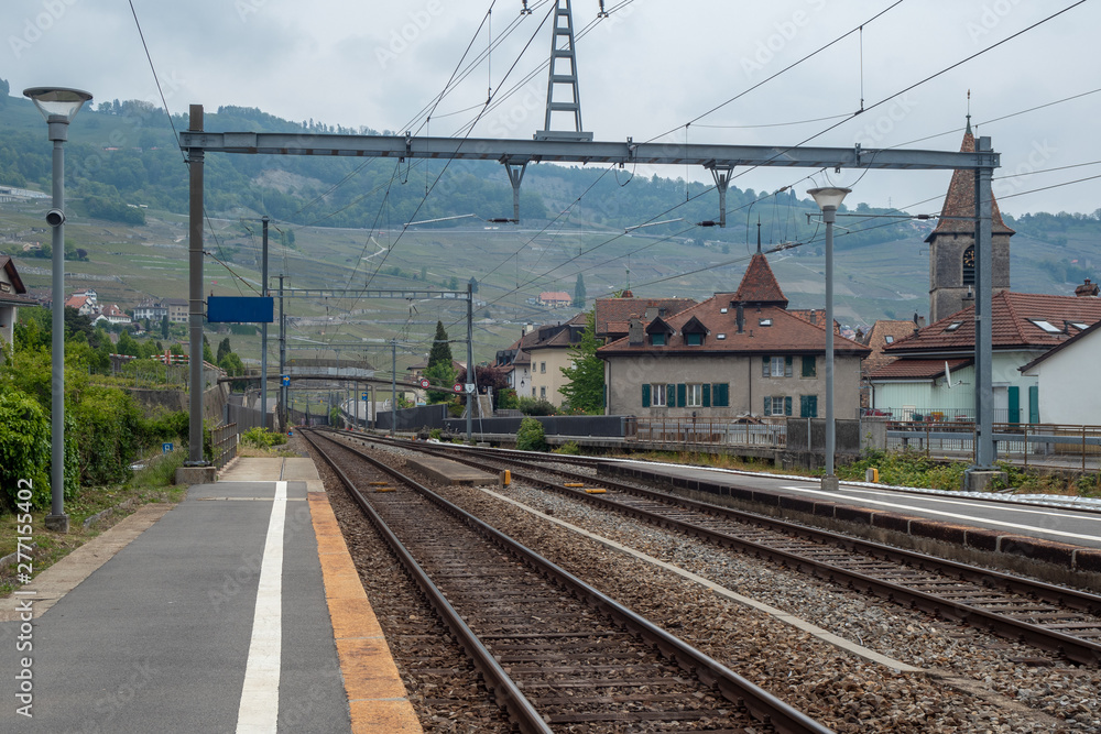 Empty platform in a small rural town of Switzerland on mountain and vintage houses background and copy space
