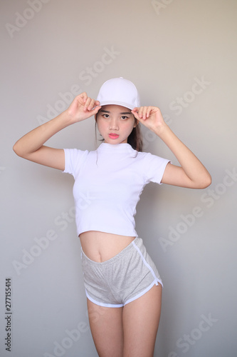 Asian girl wearing sportswear attire shots body length.