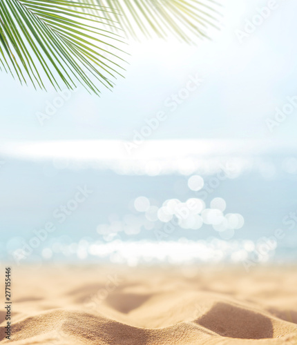Fototapeta Naklejka Na Ścianę i Meble -  Sand with blurred Palm and tropical beach bokeh background, Summer vacation and travel concept. Copy space.