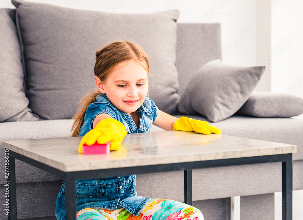 Little girl cleaning wooden table Little girl cleaning wooden table