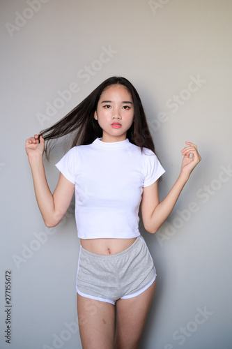 Asian girl wearing sportswear attire shots body length.