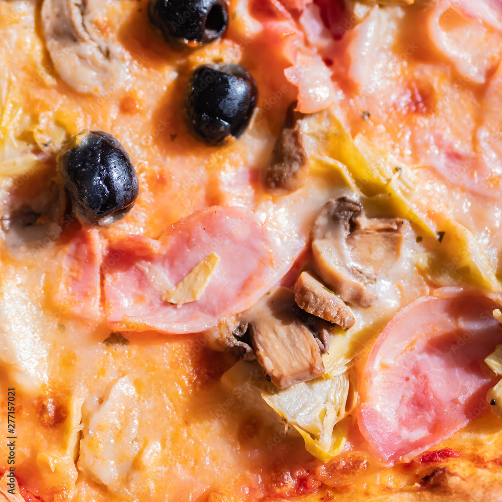 Close up of an Italian pizza with olives, ham, mushrooms and cheese. Close up of an Italian pizza with olives, ham, mushrooms and cheese.