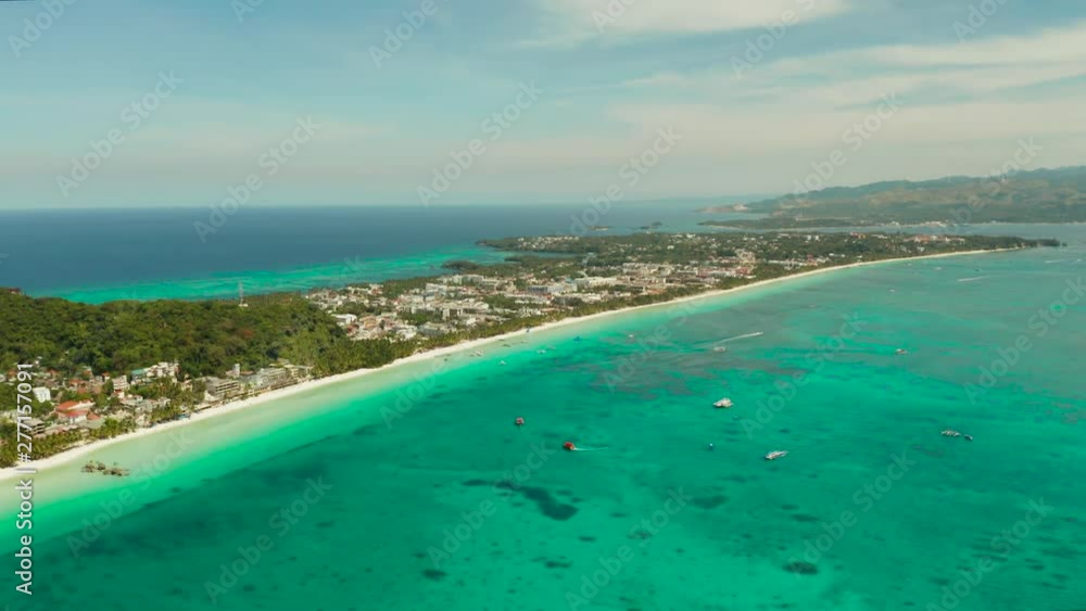 Aerial view of beautiful bay in tropical Island with white sand beach Boracay, Philippines. White beach with tourists and hotels. Tropical white beach with sailing boat. Aerial view of beautiful bay in tropical Island with white sand beach Boracay, Philippines. White beach with tourists and hotels. Tropical white beach with sailing boat.