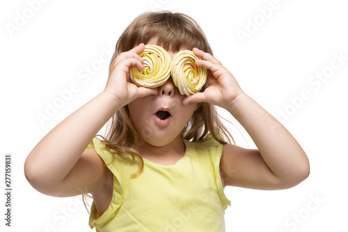 happy little girl in yellow clothes, from two big candies made eyes, emotions and gestures, surprise, on a white background