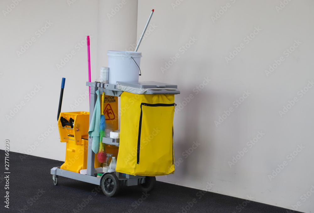 Closeup of janitorial, cleaning equipment and tools for floor cleaning with white wall background. Closeup of janitorial, cleaning equipment and tools for floor cleaning with white wall background.
