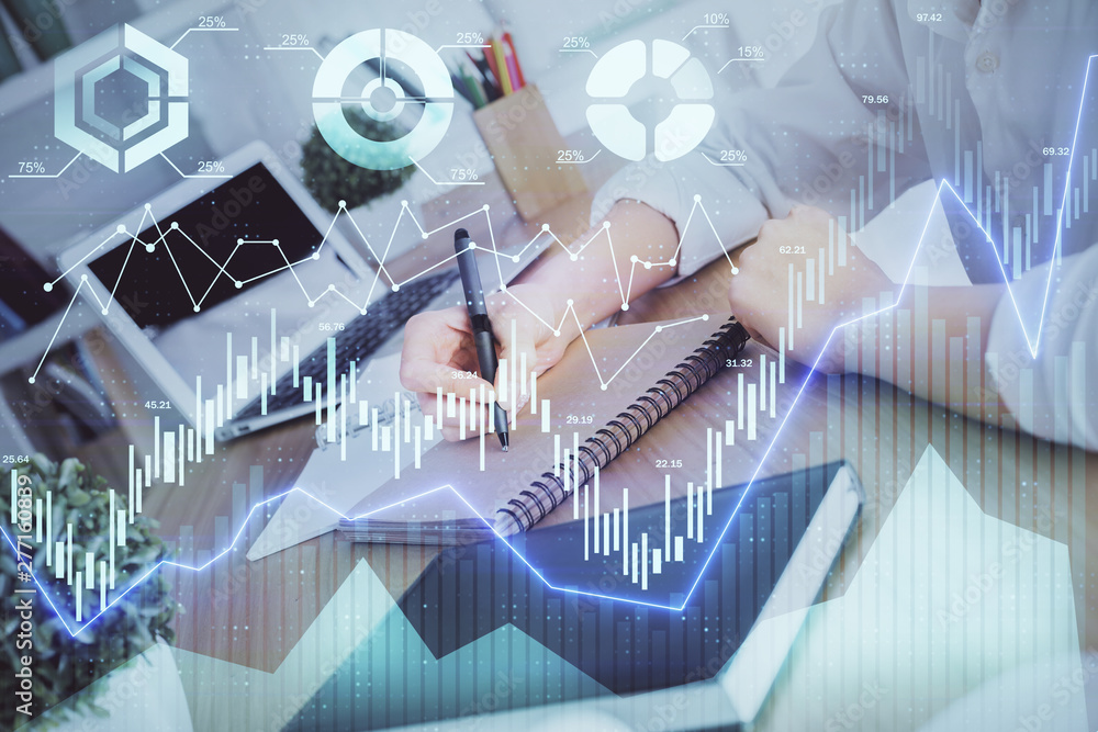 Financial graph displayed on woman's hand taking notes background. Concept of research. Double exposure Financial graph displayed on woman's hand taking notes background. Concept of research. Double exposure