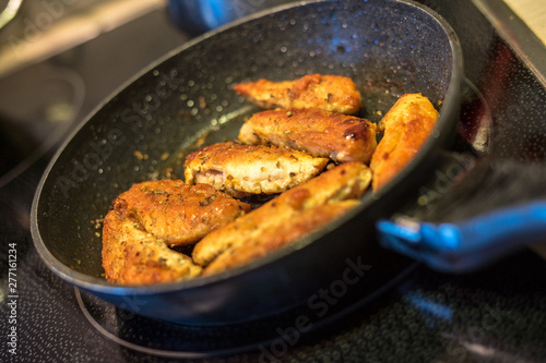 spiced chicken breast fillets in the pan