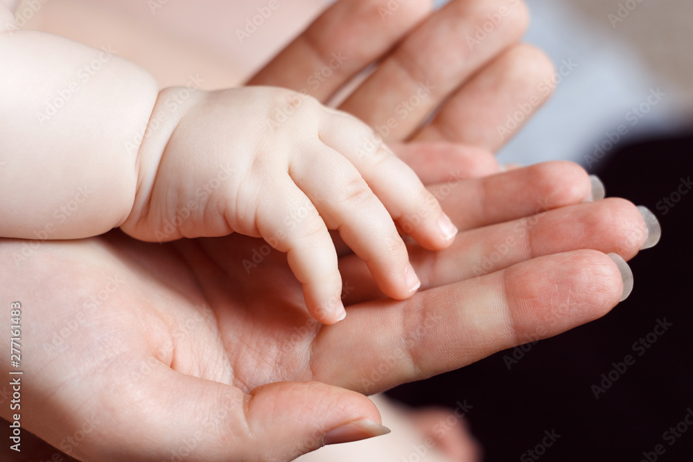 Parent hands holding newborn baby fingers. Happy family concept. Parent hands holding newborn baby fingers. Happy family concept.