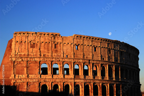 The Colosseum in Rome seen from the east, under the moon and lit up by a soft January morning light photo