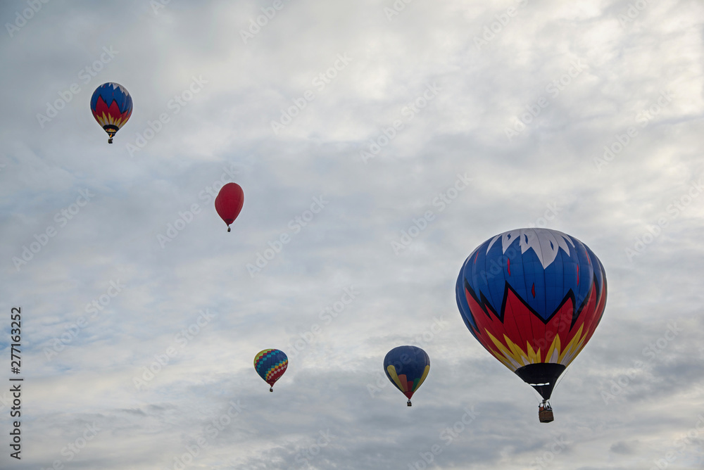 Fototapeta premium Multicolored hot air balloons on a blue cloudy sky