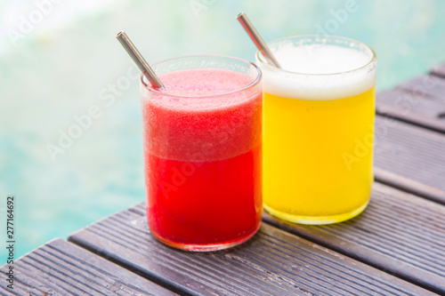 Delicious healthy summer drinks, watermelon and pineapple juice in glasses with reusable drinking straws