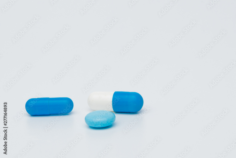 Macro view of capsule pill and tablet isolated over white background Macro view of capsule pill and tablet isolated over white background