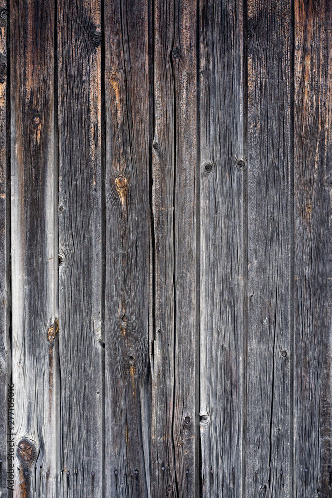 old peeling wooden boards. Background natural wooden boards. Texture of old unpainted wooden planks. Vertical arrangement of shabby wooden boards. old peeling wooden boards. Background natural wooden boards. Texture of old unpainted wooden planks. Vertical arrangement of shabby wooden boards.
