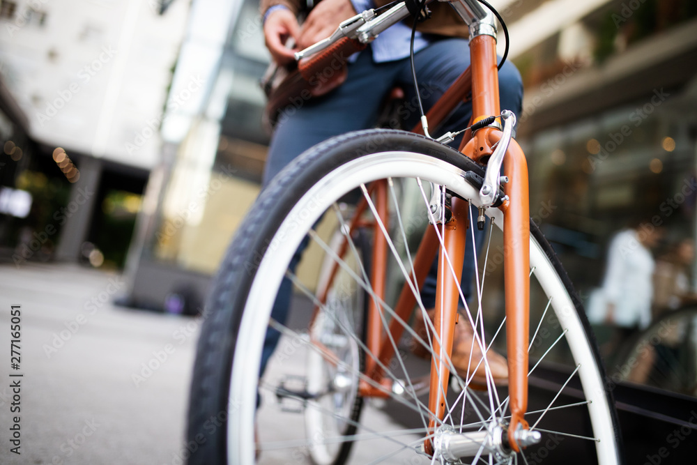 Happy businessman riding bicycle to work in morning Happy businessman riding bicycle to work in morning