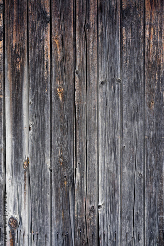 old peeling wooden boards. Background natural wooden boards. Texture of old unpainted wooden planks. Vertical arrangement of shabby wooden boards.