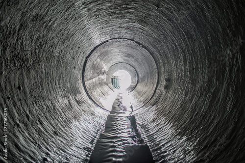 Exit from the drainage sewage tunnel pipe. Concrete Drainage Pipe, collector of city sewage system photo