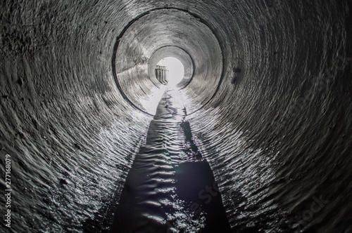 Exit from the drainage sewage tunnel pipe. Concrete Drainage Pipe, collector of city sewage system photo