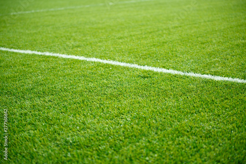 Photo of green soccer field with white stripe,