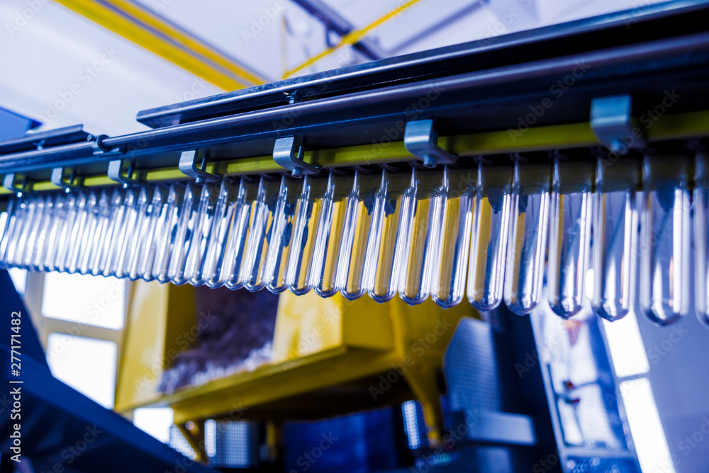 The plastic bottle blowing machine. PET preforms for blowing of plastic bottles. Heating process. The plastic bottle blowing machine. PET preforms for blowing of plastic bottles. Heating process.