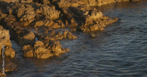Rocks lapped by the sea on the Croatian Adriatic coast at sundown