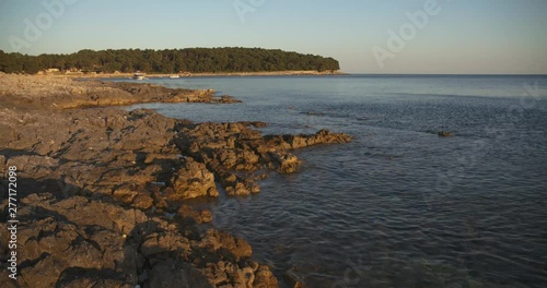 Rocks lapped by the sea on the Croatian Adriatic coast at sundown