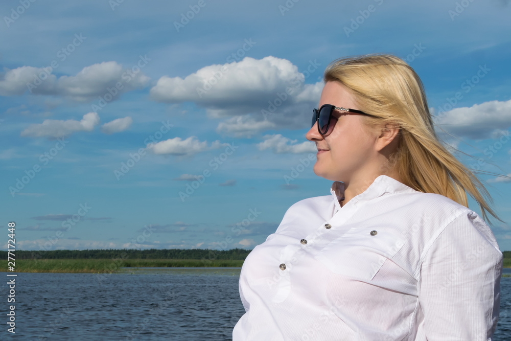 portrait of a girl with glasses against a blue cloudy sky portrait of a girl with glasses against a blue cloudy sky