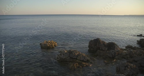 Rocks lapped by the sea on the Croatian Adriatic coast at sundown