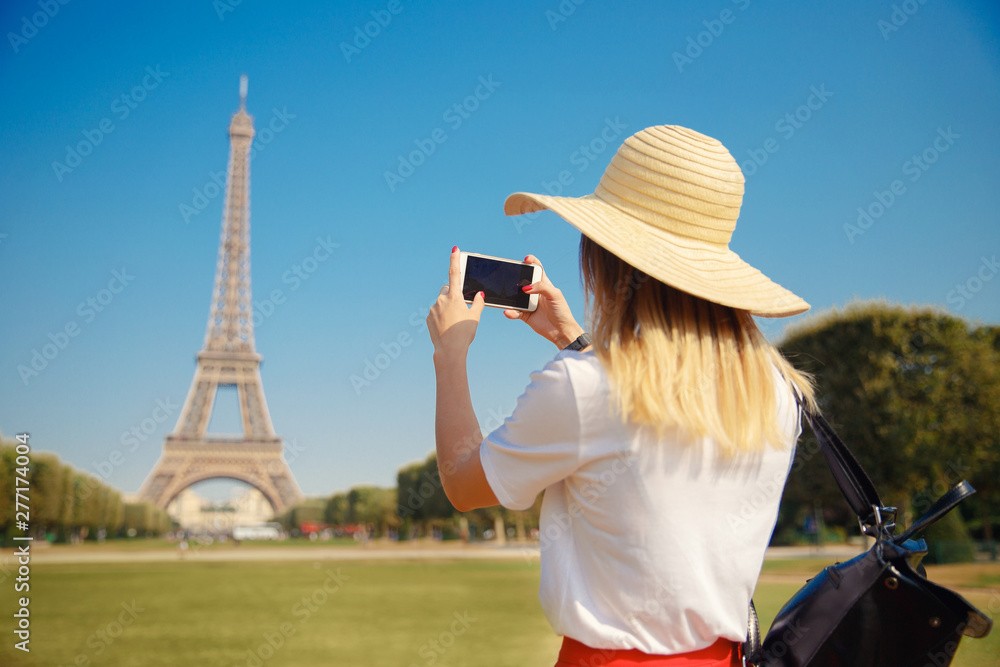 Girl tourist Eiffel tower making selfie. Beautiful European enjoying vacation in Paris, France. Concept travel