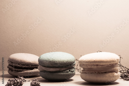  Three isolated almond macaroons in pastel colors